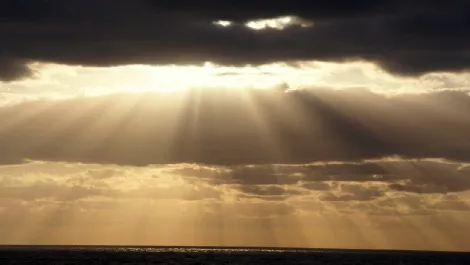 Sun shining through cloud
